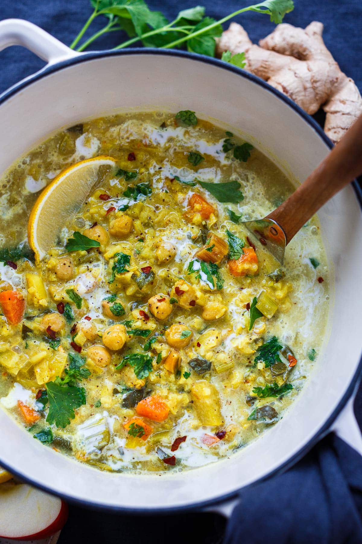 This vegan Chickpea Soup recipe is bursting with flavor! Made with veggies and rice in a golden turmeric coconut milk broth. A cheery soup for cozy winter days. Gluten-free.