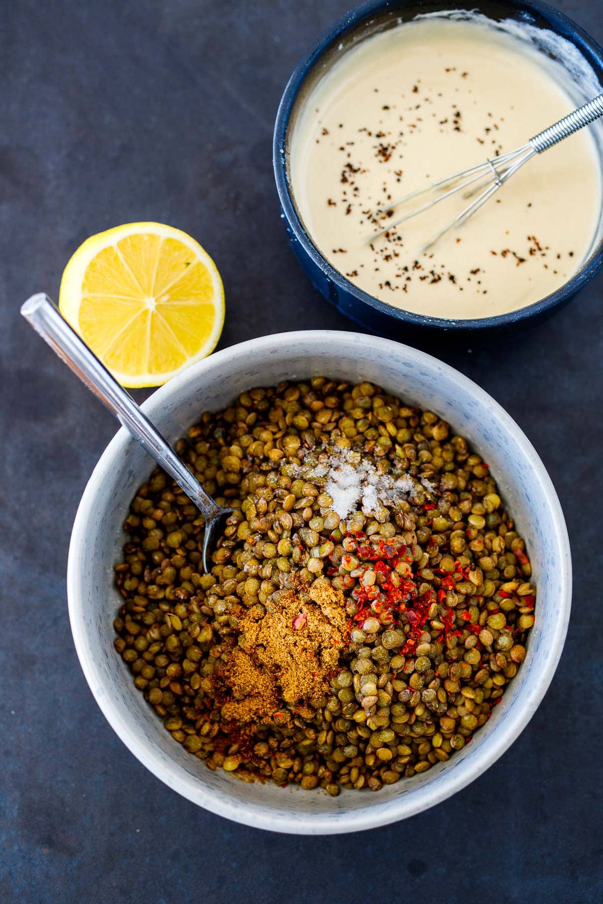 seasoning the lentils and a bowl of tahini sauce. 