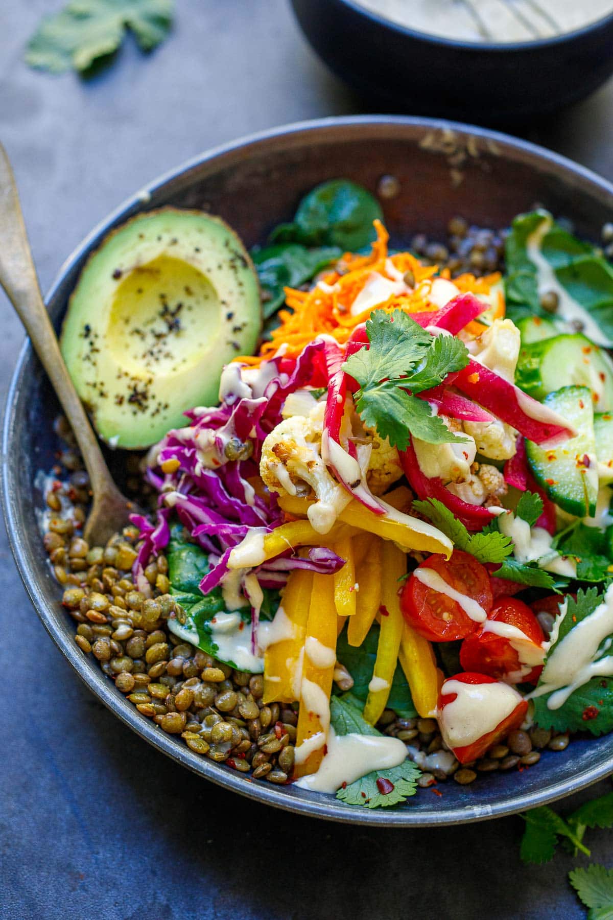 Lentil bowls with lots of veggies and tahini sauce. 