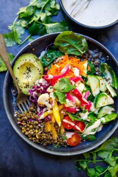 These grain-free Lentil Bowls are so nourishing and delicious! Made with seasoned lentils, fresh seasonal veggies, dark leafy greens, fresh herbs or microgreens, nuts or seeds, avocado, and our favorite tahini sauce!  Vegan, gluten-free and grain-free!These grain-free Lentil Bowls are so nourishing and delicious! Made with seasoned lentils, fresh seasonal veggies, dark leafy greens, fresh herbs or microgreens, nuts or seeds, avocado, and our favorite tahini sauce!  Vegan, gluten-free and grain-free!