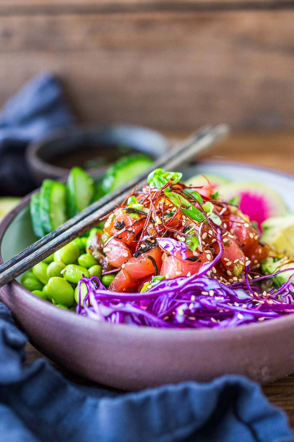 How to make homemade Poke Bowls with fresh ahi tuna, avocado, cucumbers, shredded cabbage, edamame, and rice, with a bright and flavorful Poke dressing.