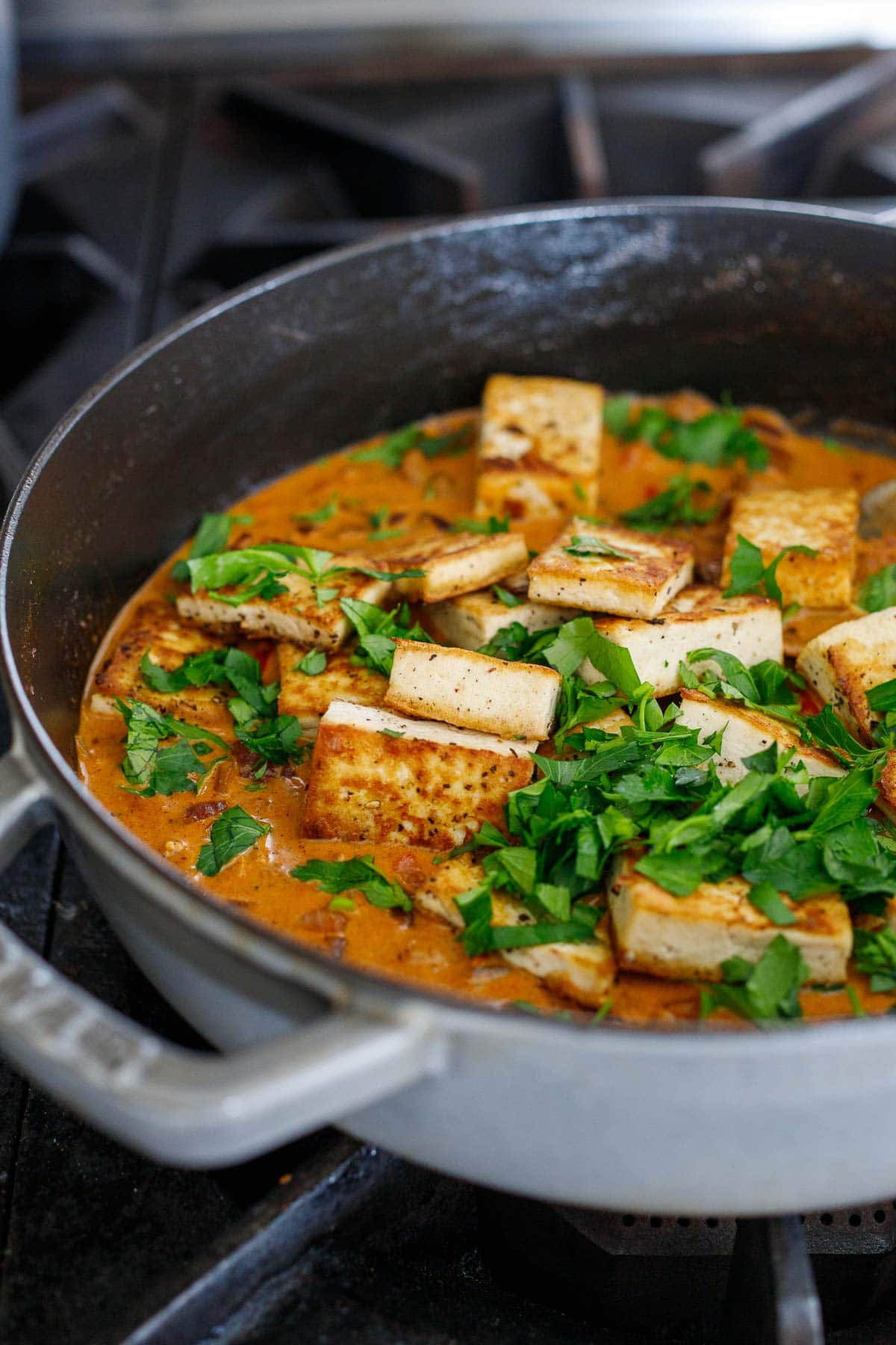 fried, crispy, golden tofu and freshly minced parsley tossed into pan with simmering paprikash sauce.