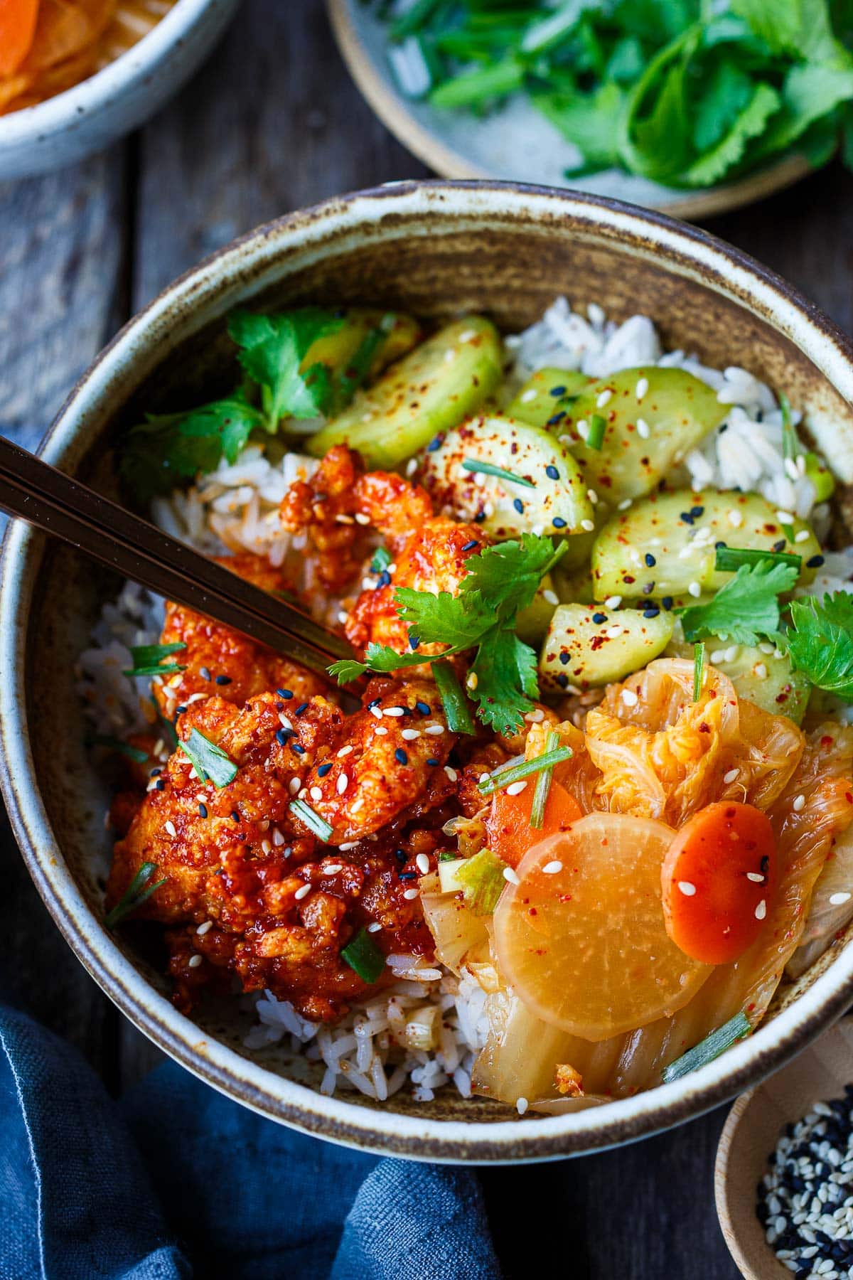 Korean tofu bowl made with jasmine rice, gochujang tofu, kimchi, and cucumber salad.