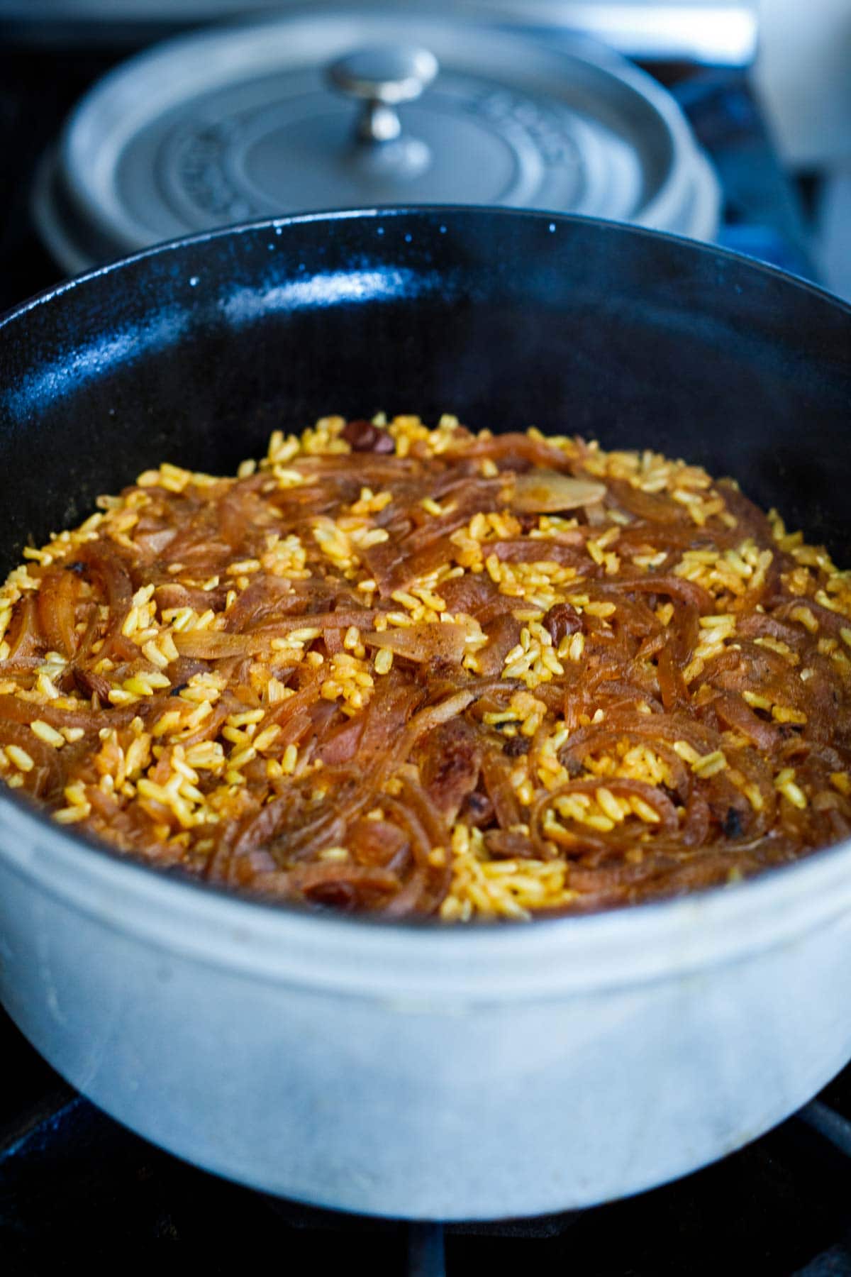 Moroccan rice pilaf with caramelized onions done cooking in dutch oven.
