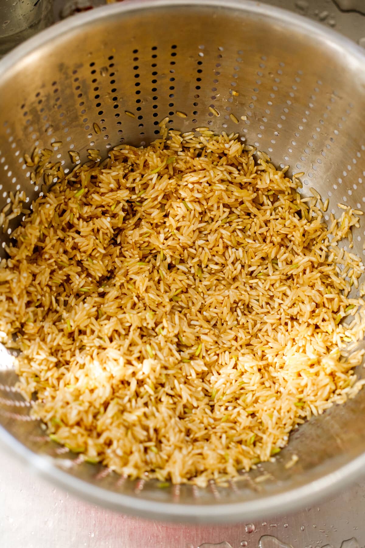 drained basmati rice in colander, ready for cooking.