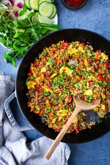A tasty recipe for vegetarian Nasi Goreng (Indonesian Fried Rice) loaded up with fresh, healthy veggies! Keep it vegetarian with Turmeric Tofu (or add chicken or shrimp!)—a fast and flavor-packed dinner recipe the whole family will love. 
