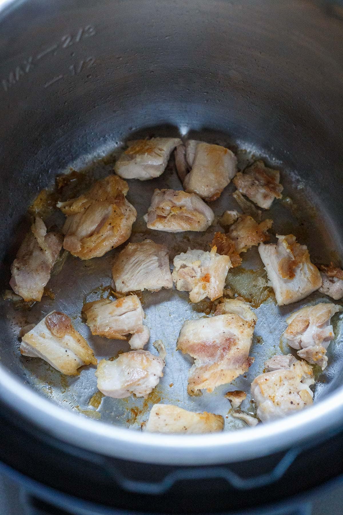 cubed chicken sautéing in instant pot to make teriykai chicken.