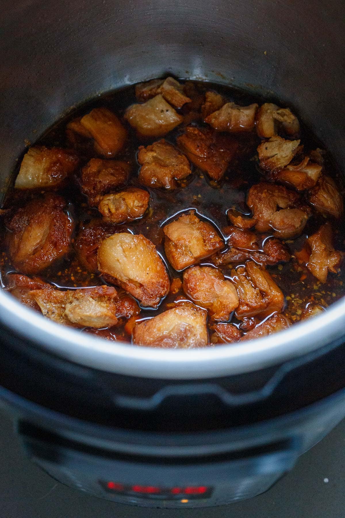cubed and seared chicken in instant pot with teriyaki sauce.