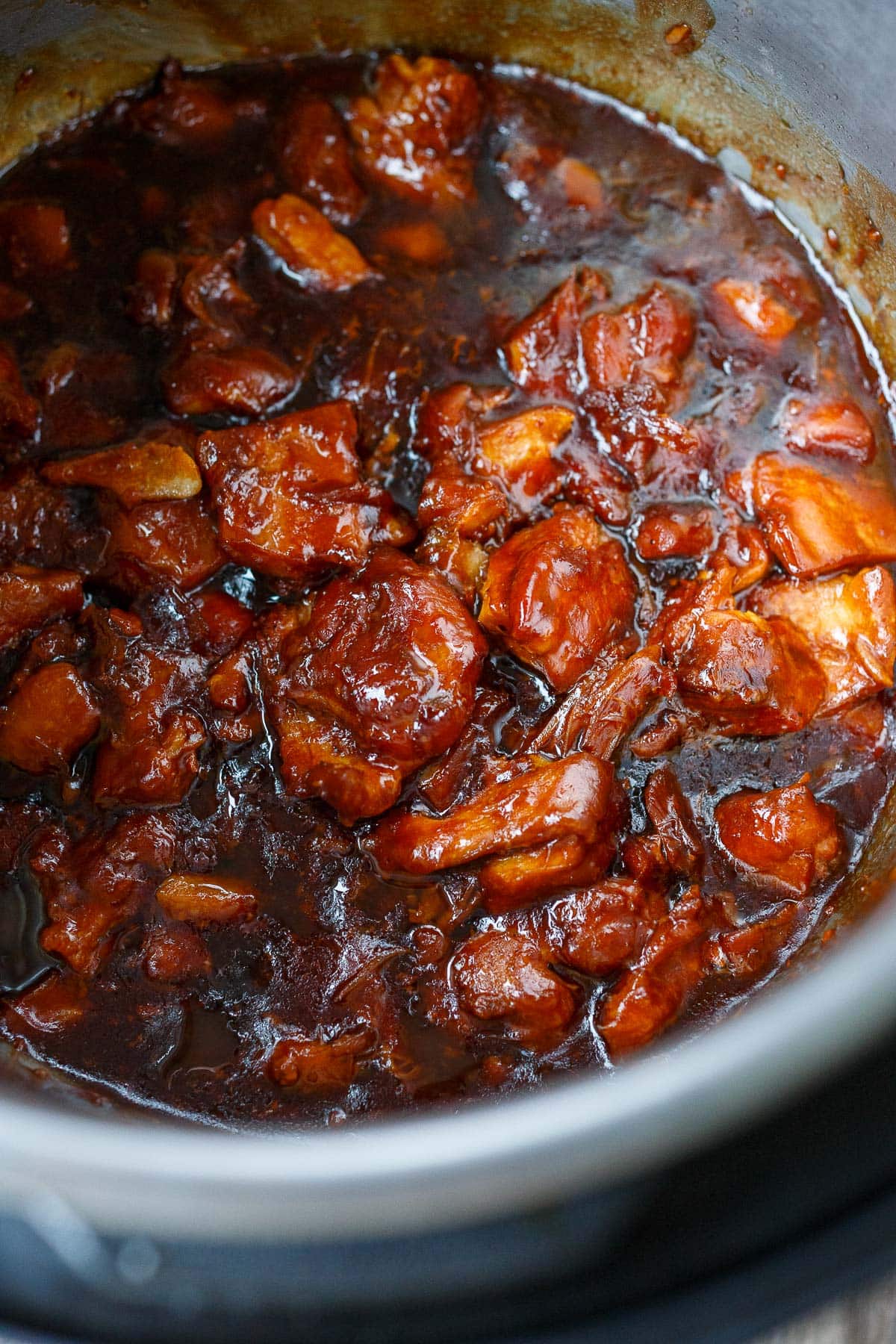 instant pot teriyaki chicken, cubed and cooking in sauce in pot.