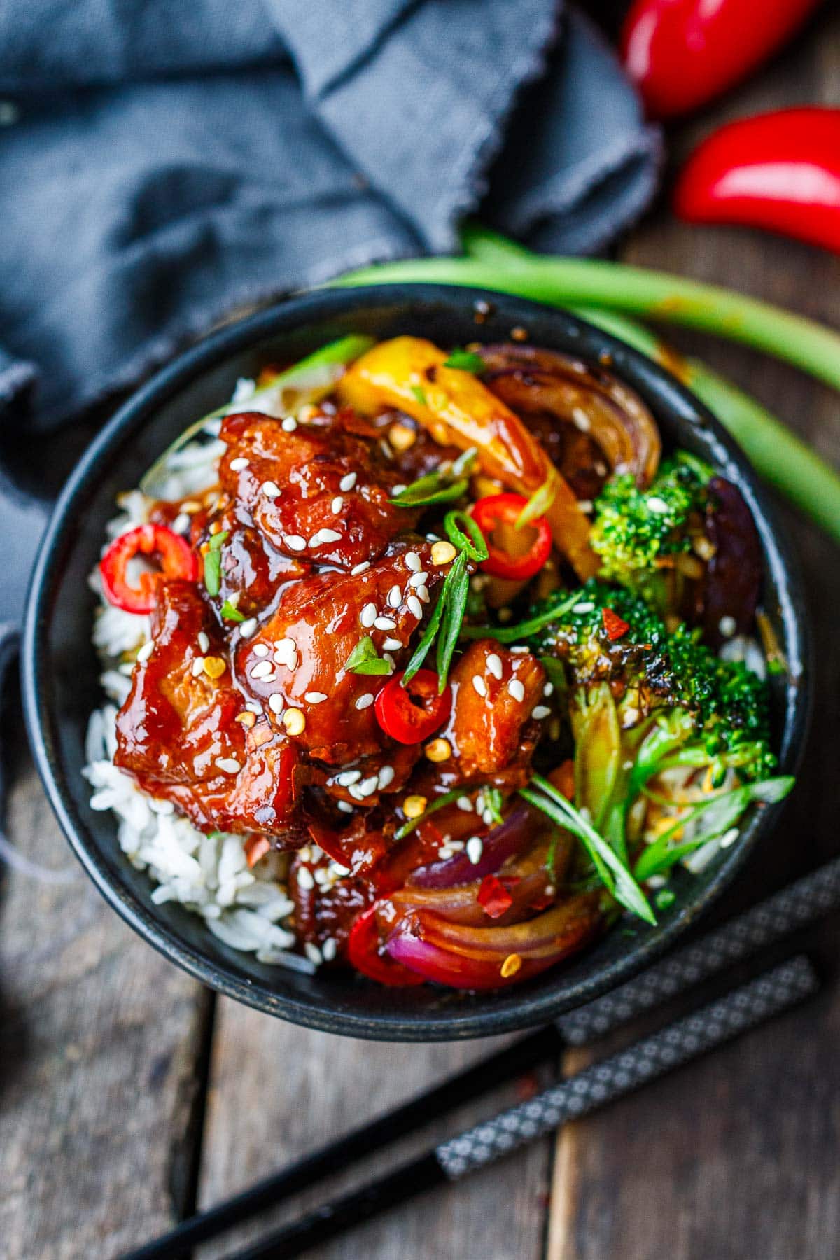 serving bowl with instant pot teriyaki chicken, with broccoli and onions, chilis and scallions.