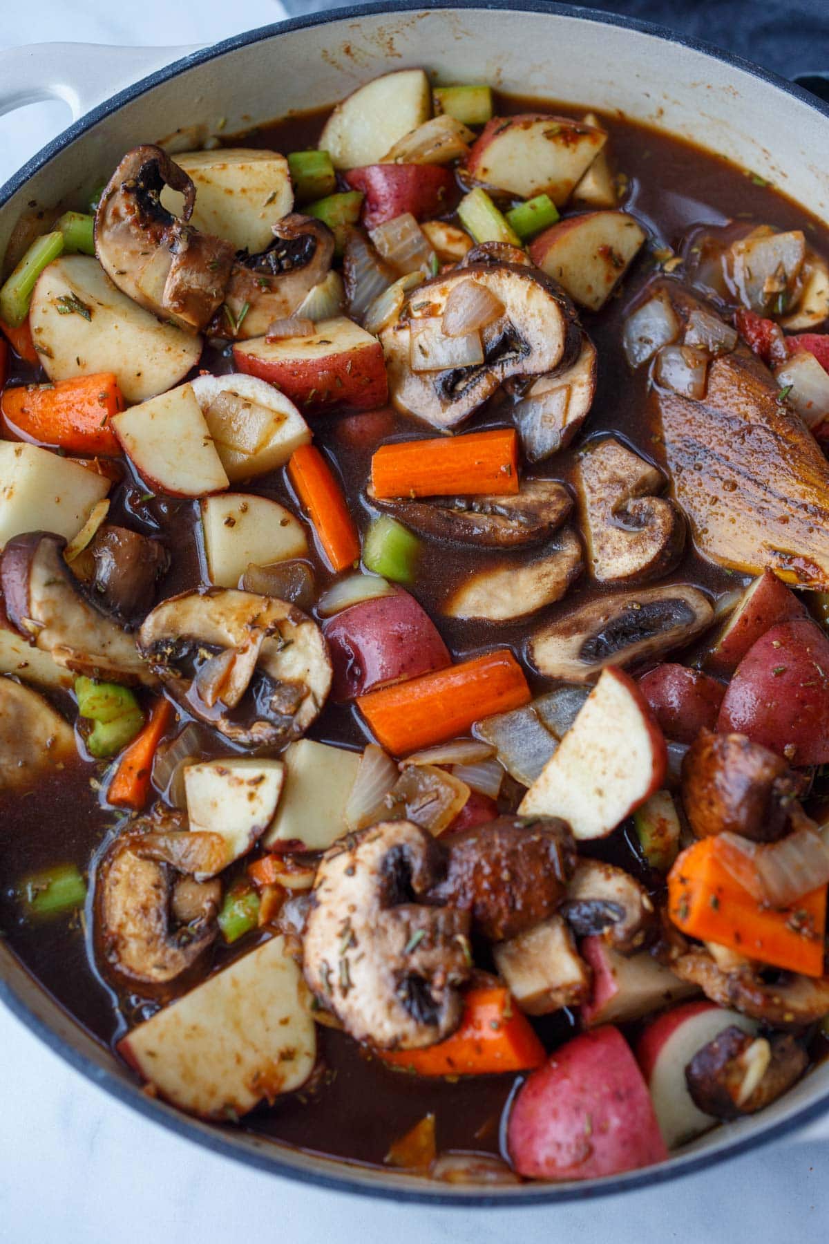 veggies for vegetable stew simmering in pan with homemade broth.