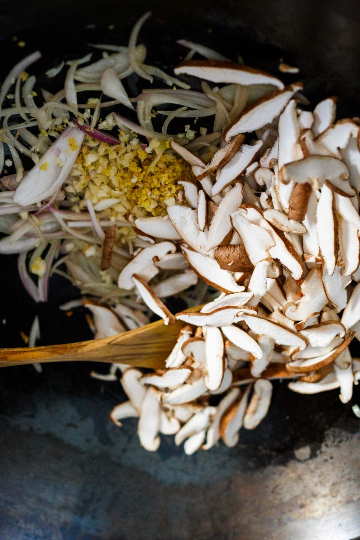 shiitake mushrooms, garlic, ginger, shallots, stirred in wok.