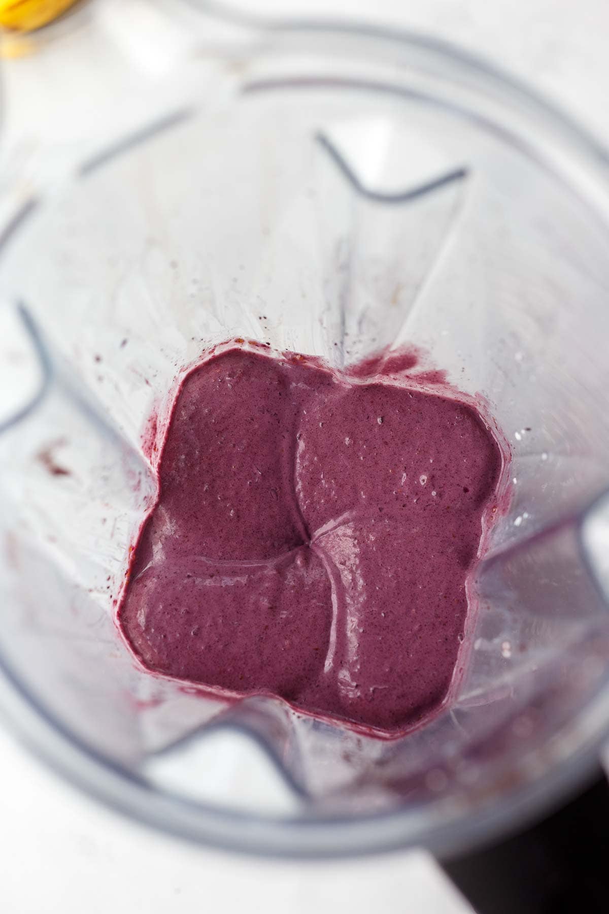 acai bowl blended into smooth, thick texture in blender.