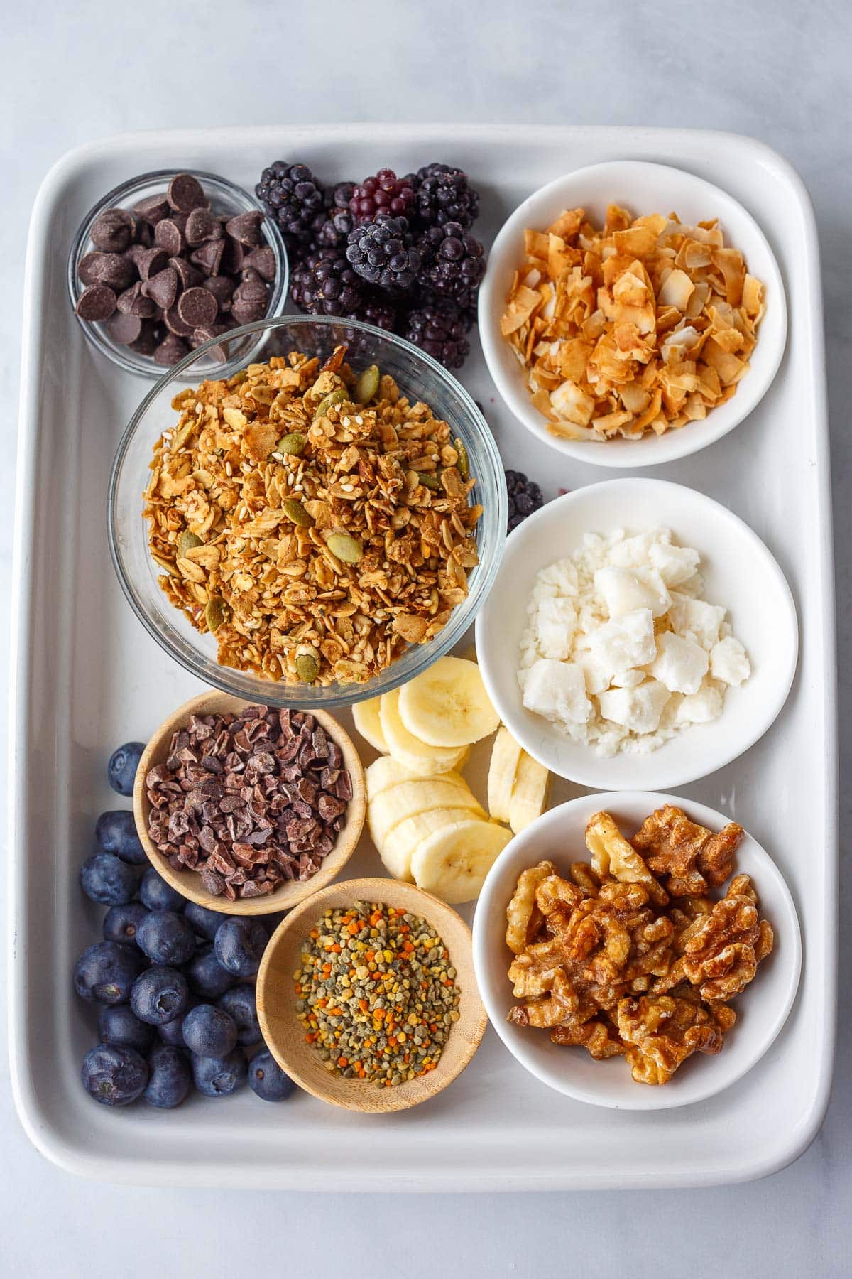 toppings for acai bowls- dark chocolate chips, blackberries, toasted coconut, granola, sliced bananas, walnuts, bee pollen, cacao nibs, blueberries.