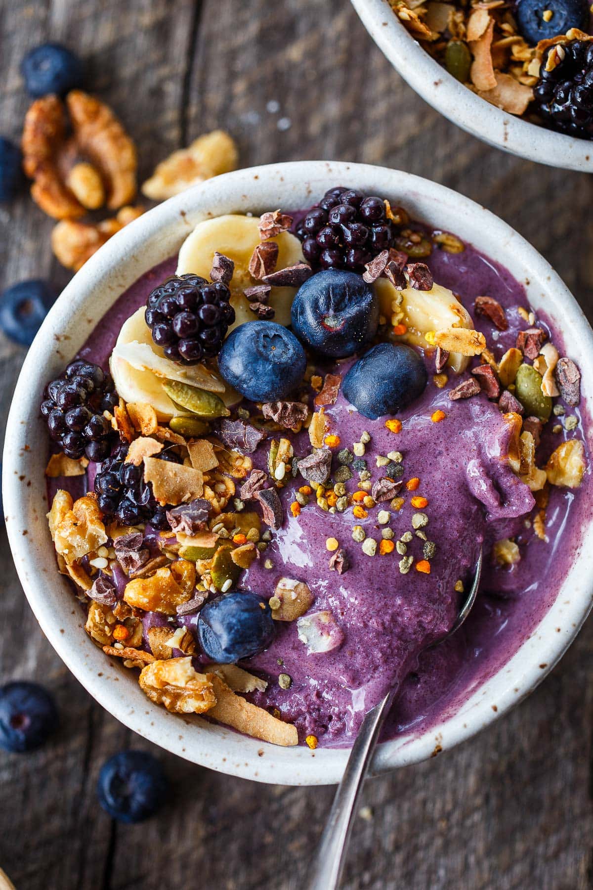 acai bowl with toppings- berries, sliced banana, granola, bee pollen, cacao nibs, toasted coconut. 