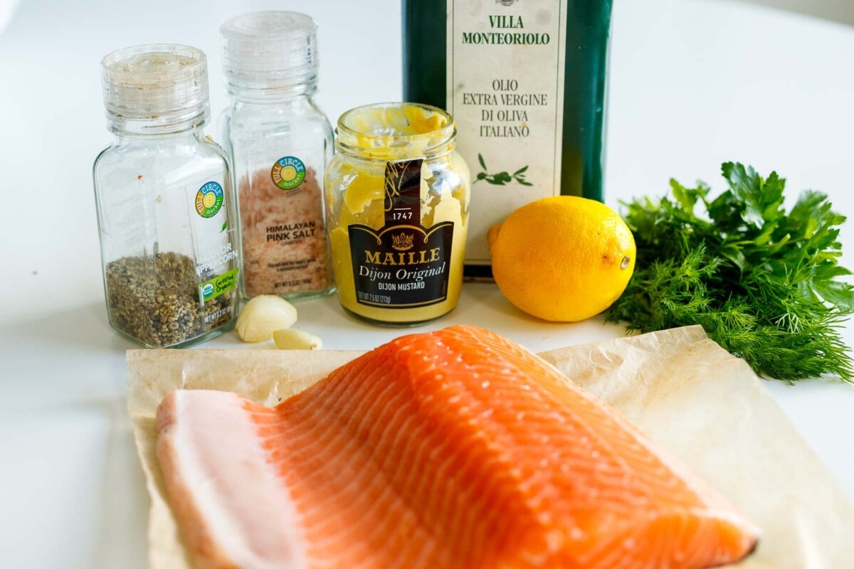 ingredients for baked dijon salmon- salmon, salt, pepper, garlic, dijon, lemon, herbs, oil.