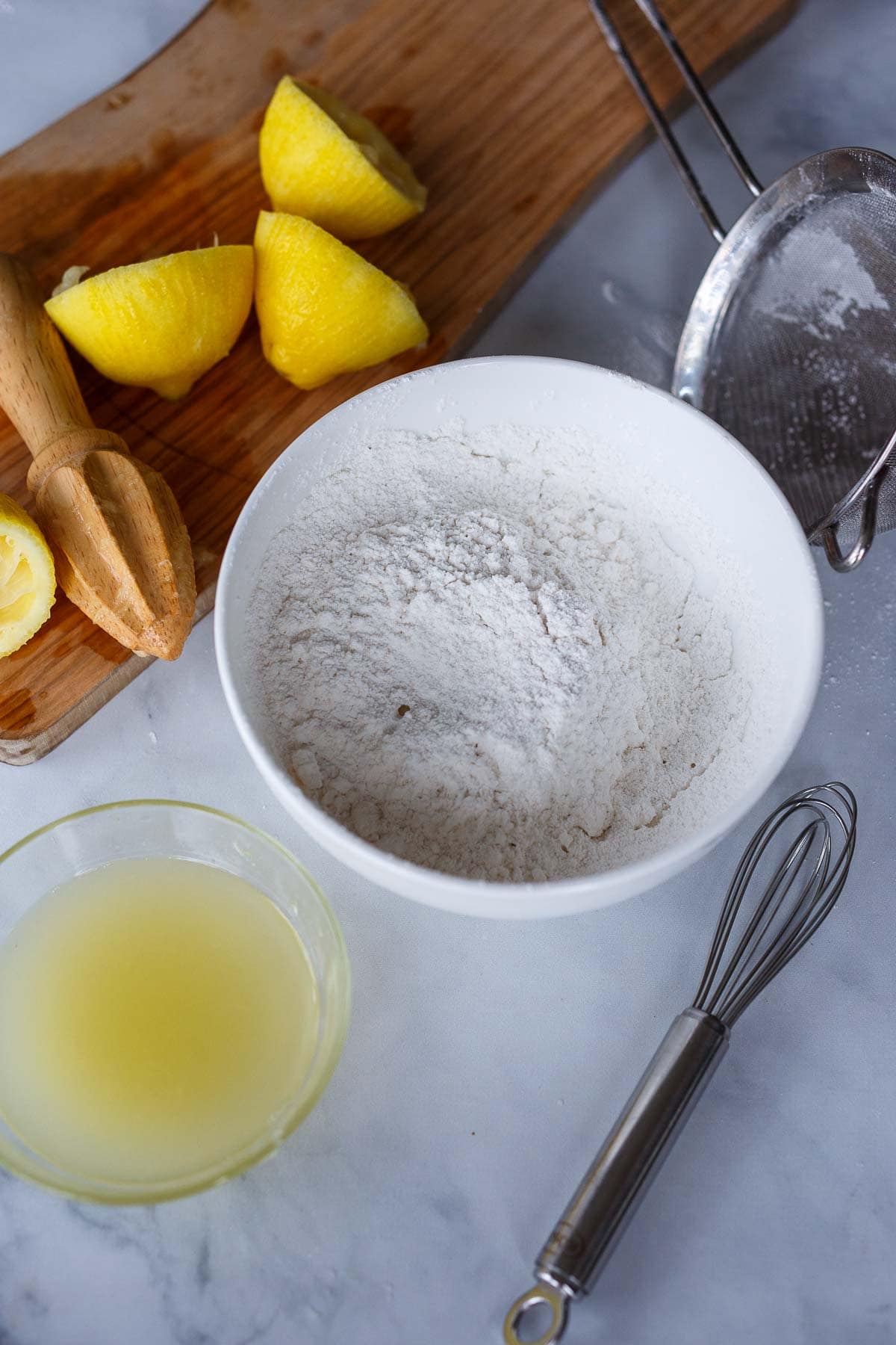 making lemon glaze with powdered sugar and lemon juice.