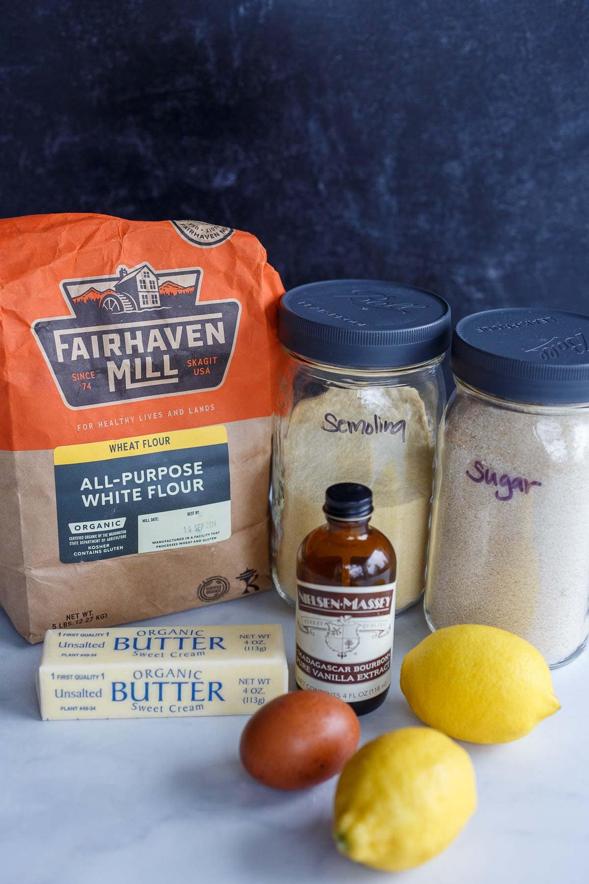 ingredients for lemon cookies- all purpose flour, semolina, sugar, butter, vanilla, egg, lemons.