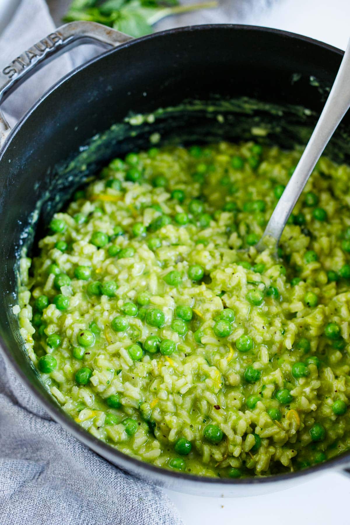 cracked pepper and lemon zest added to pot with spring pea risotto. 