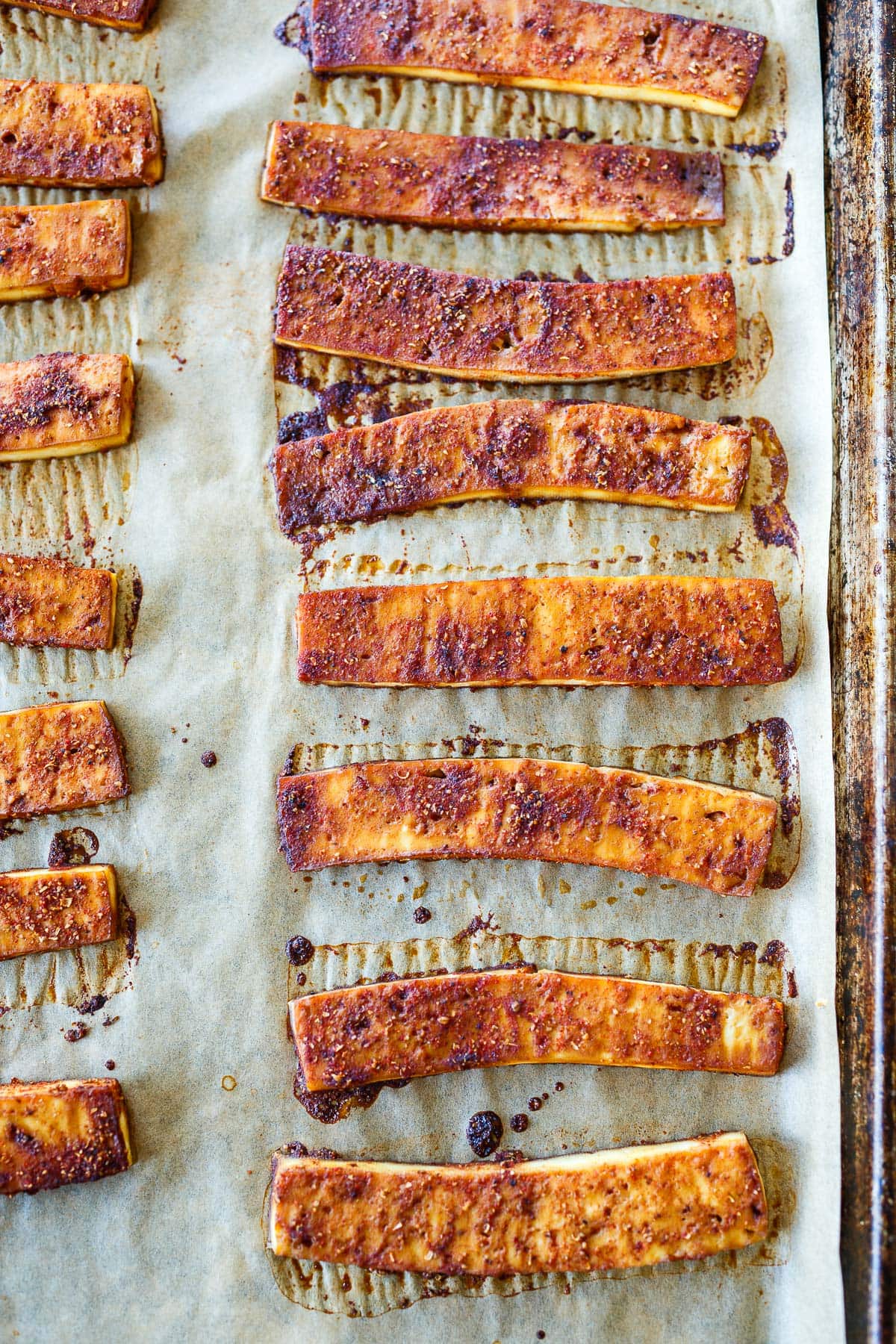 baked vegan bacon on parchment-lined pan.