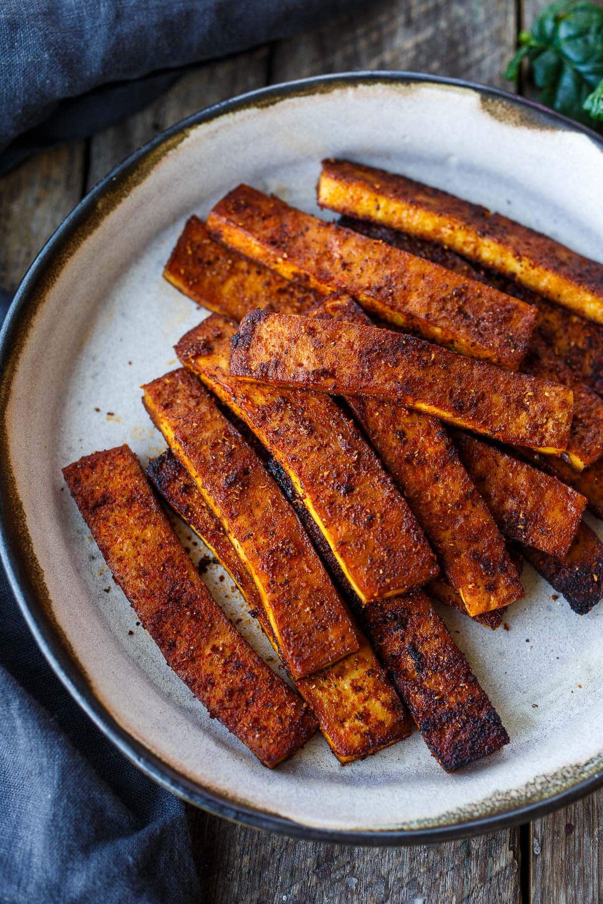 baked tofu bacon piled on plate.