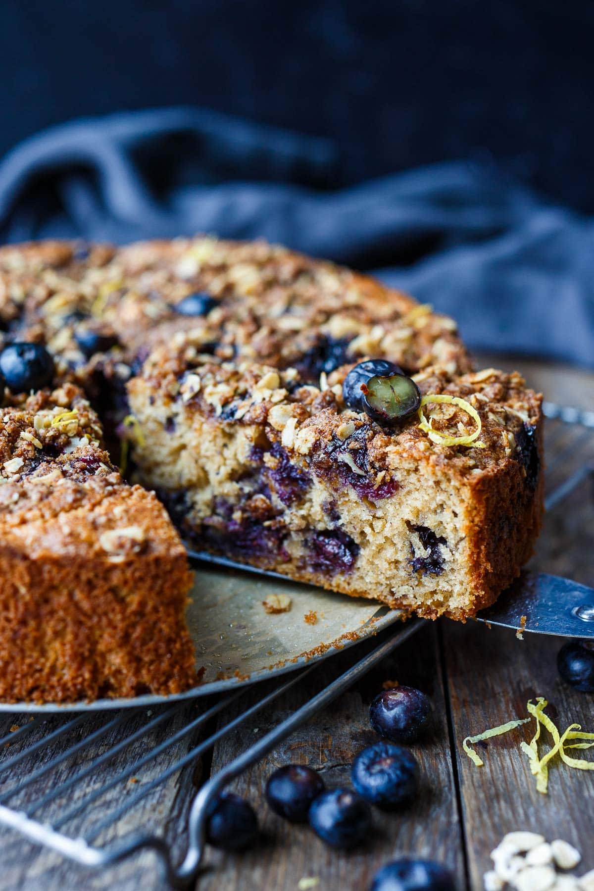 A piece of blueberry coffee cake with crumb topping. 