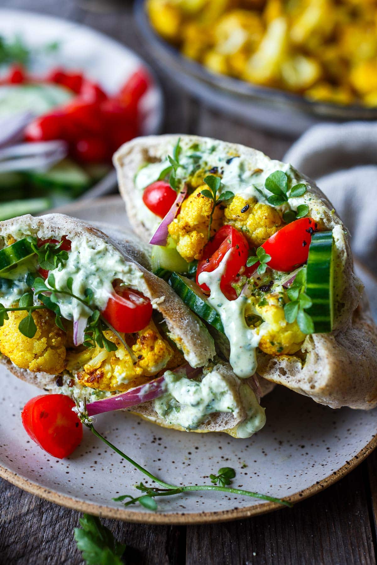 cauliflower shawarma pita wraps with zhoug yogurt sauce.