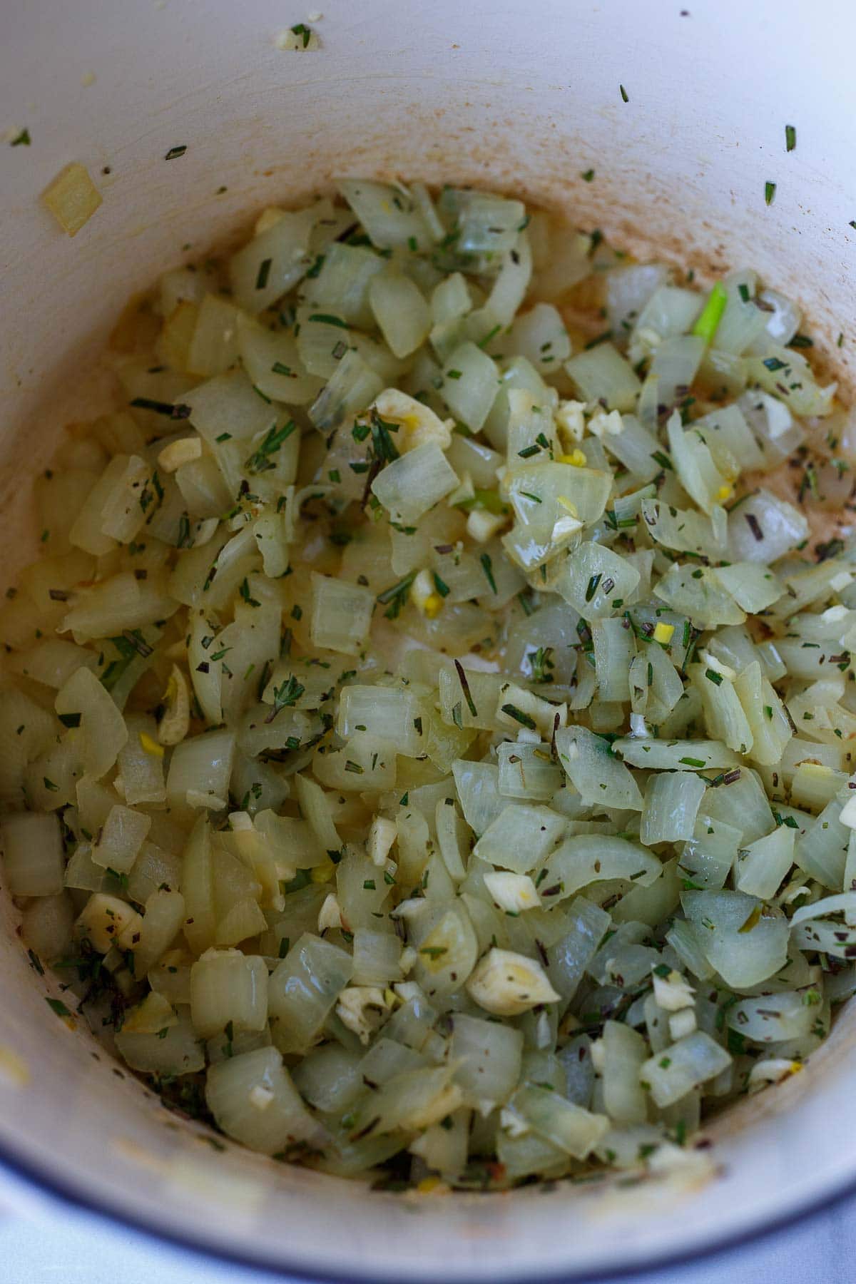 chopped onions and garlic and rosemary sauteing in pot. 