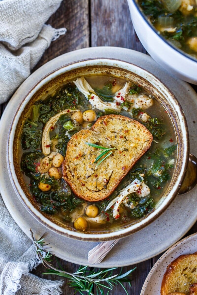 This chicken kale soup with chickpeas is comforting and delicious! It's topped with a crispy rosemary garlic crouton.