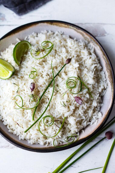 Fluffy, light and delicious, this easy Coconut Rice recipe is enhanced with coconut milk, lemongrass, and ginger. A vegan, gluten-free side dish in 30 minutes.