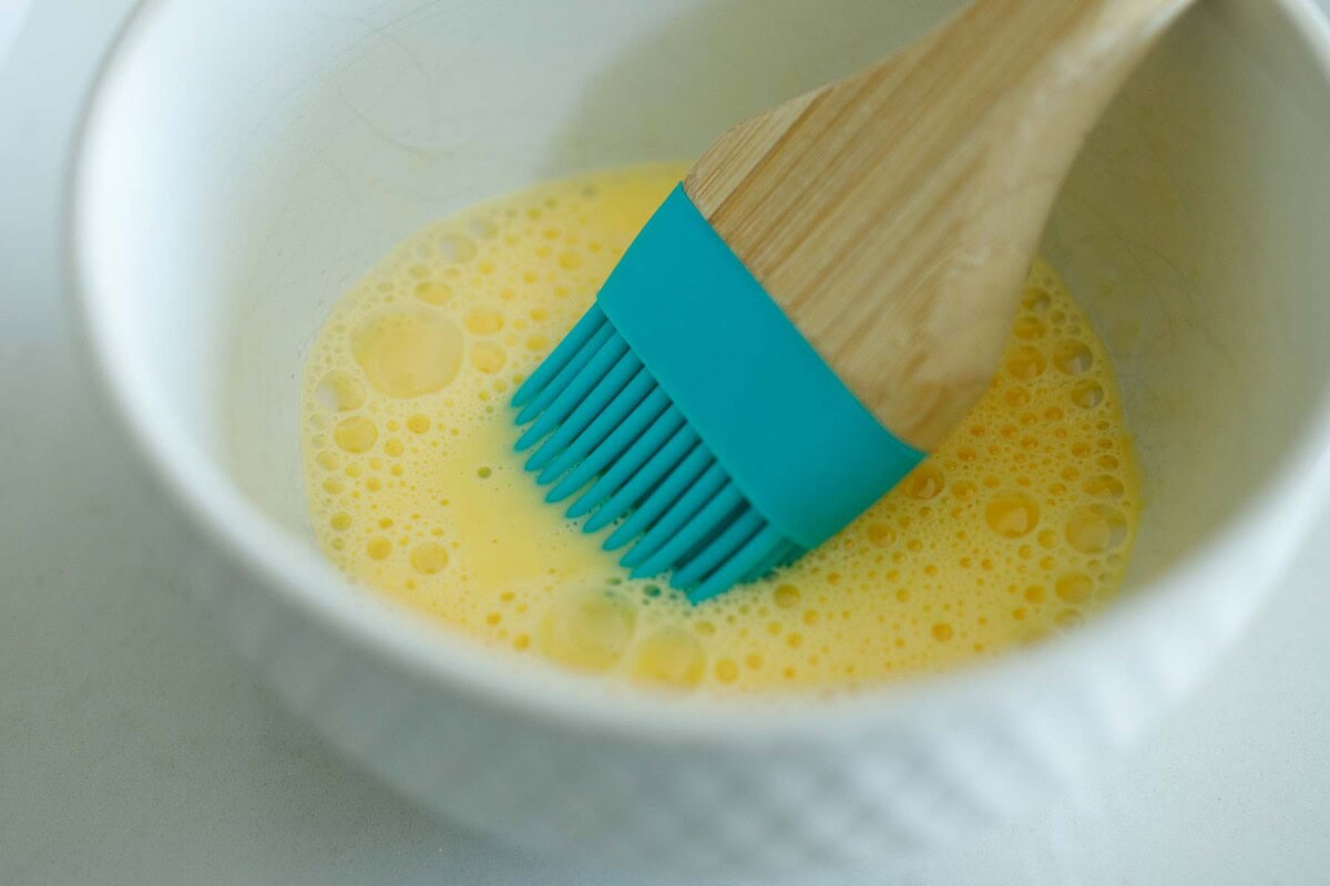 silicone pastry brush dipped into egg wash.