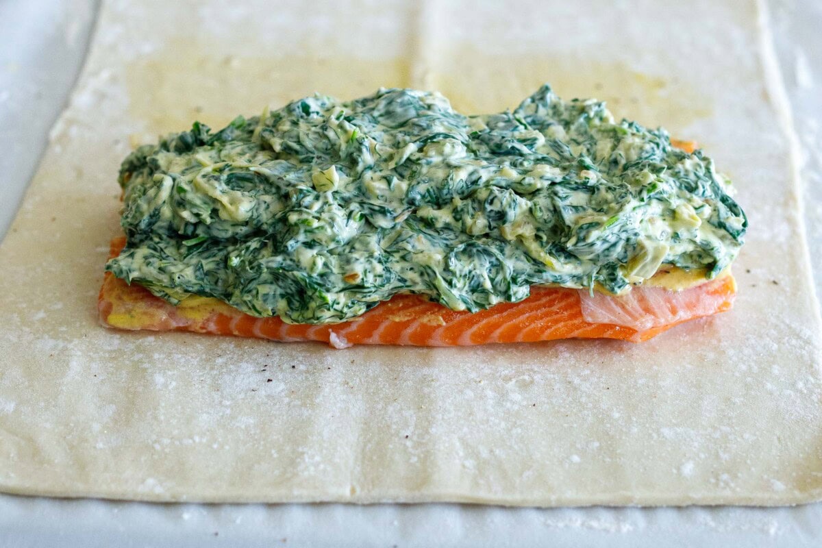 salmon topped with spinach filling, laid on top of puff pastry.