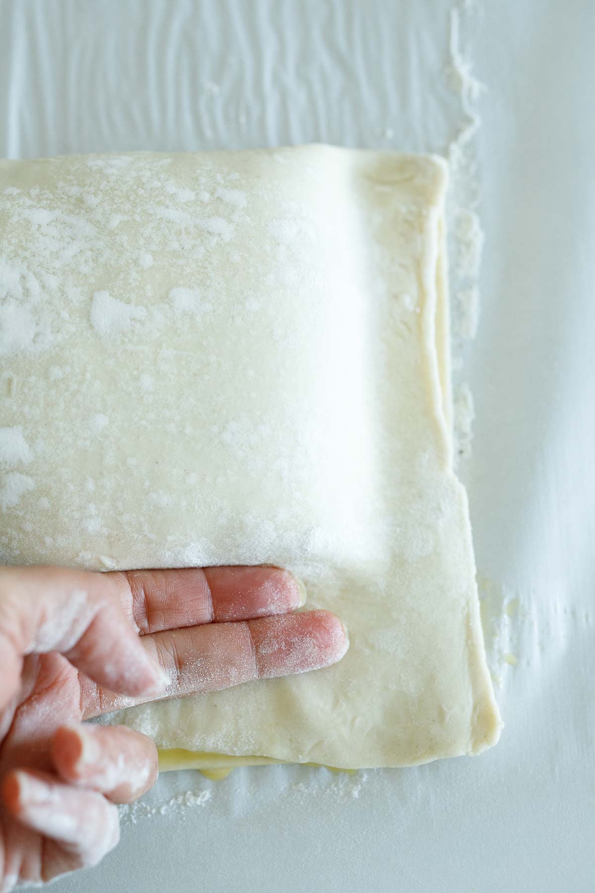 using fingers to press out any air bubbles from the salmon wellington.