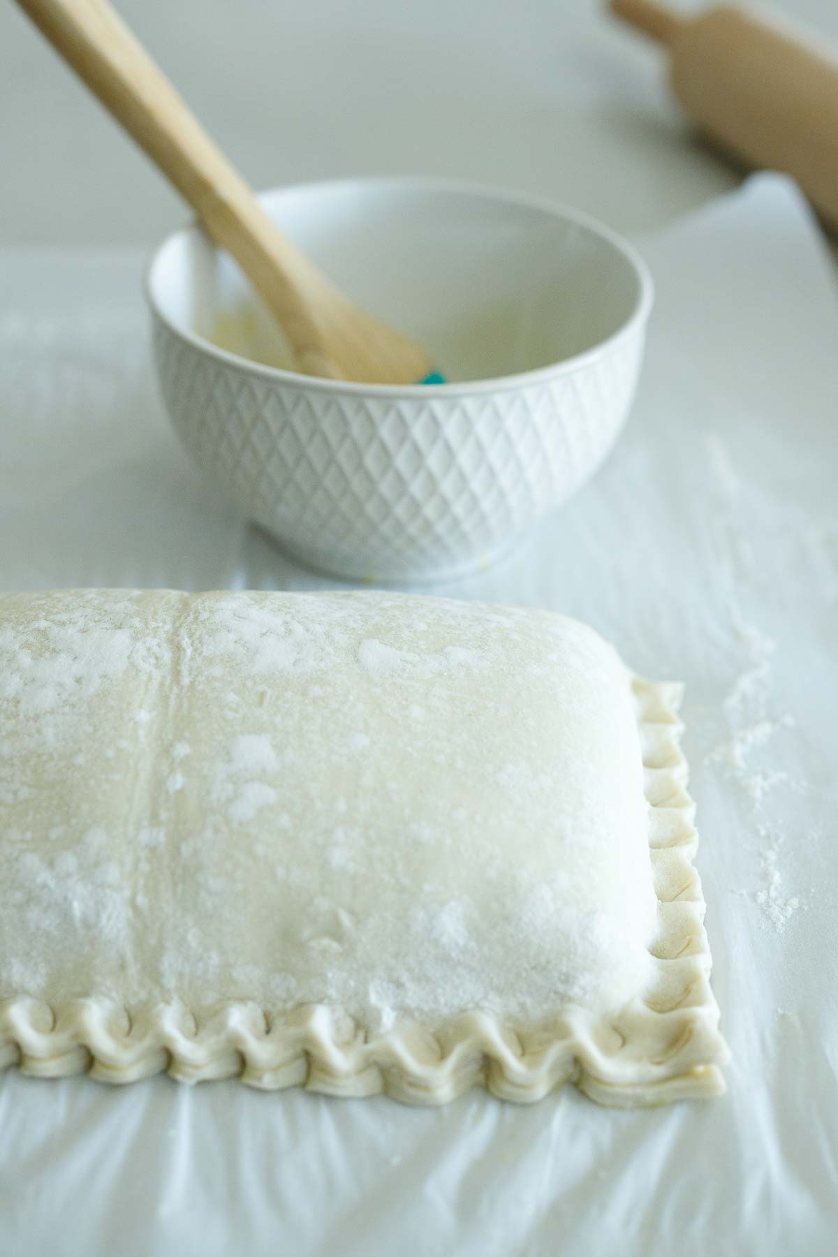 salmon wellington with puff pastry edges crimped. 