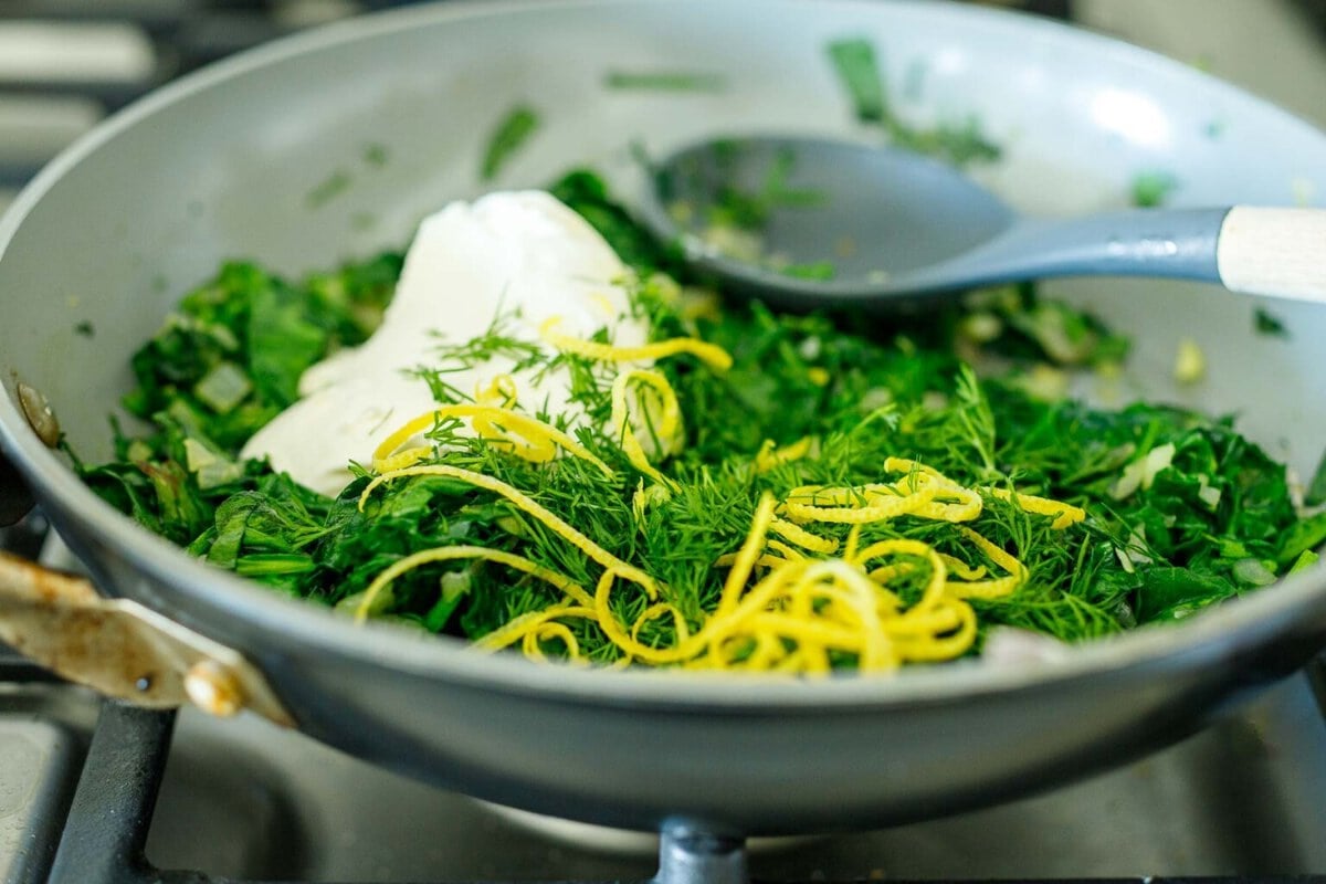 skillet with spinach and cream cheese, dill, and lemon zest added.