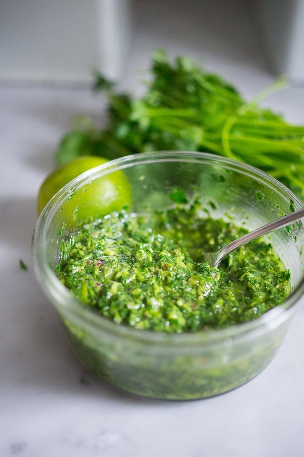 chimichurri sauce in small bowl with spoon.