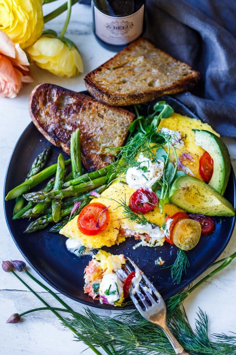 Champagne Omelette is succulent and lusciously flavorful! Filled with smoked salmon, goat cheese, fresh dill and chives. Gluten-free.
