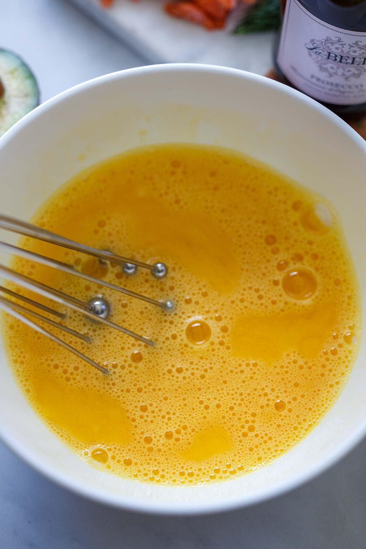 whisk in bowl of whisked eggs.