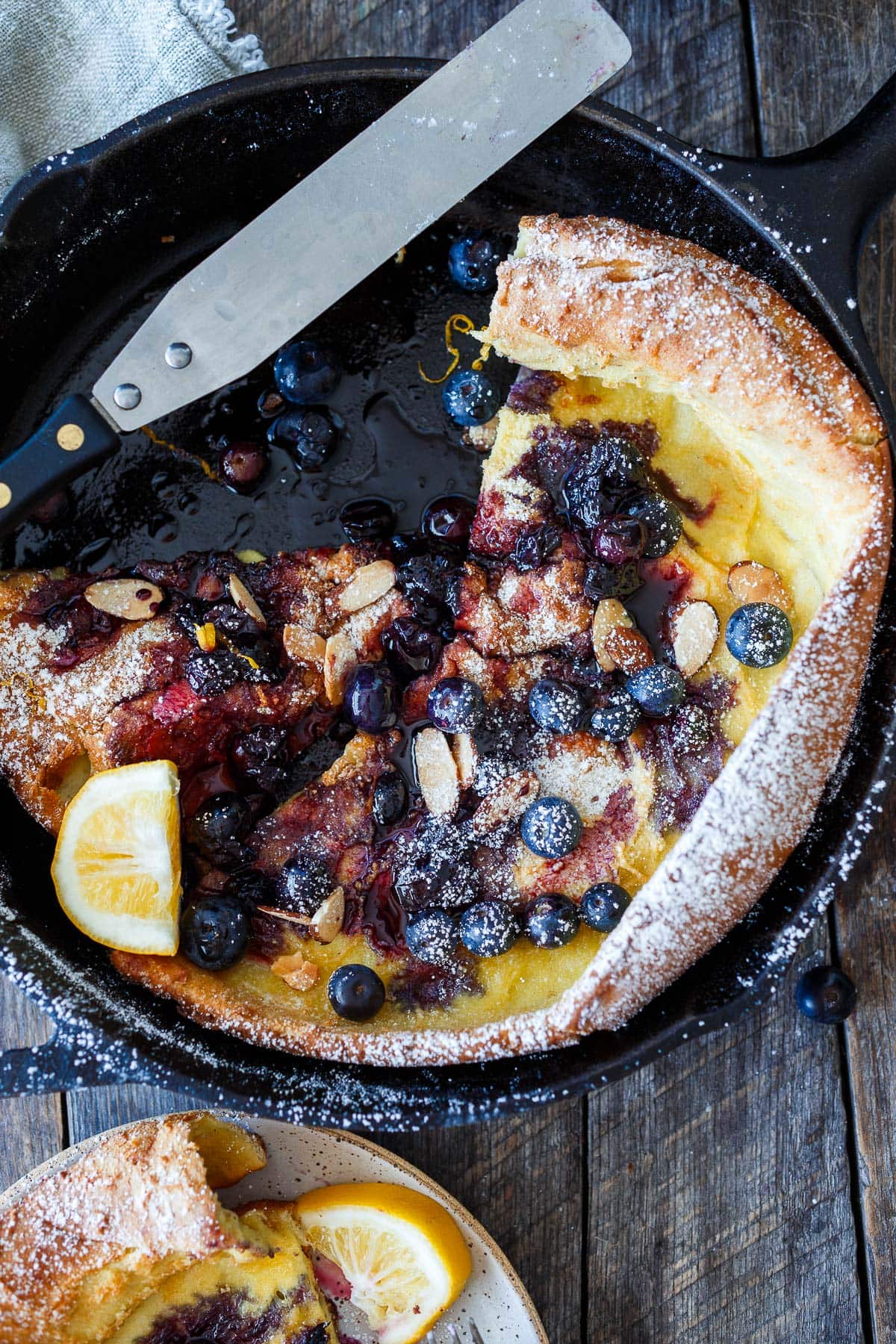 Blueberry Dutch Baby in a skillet.