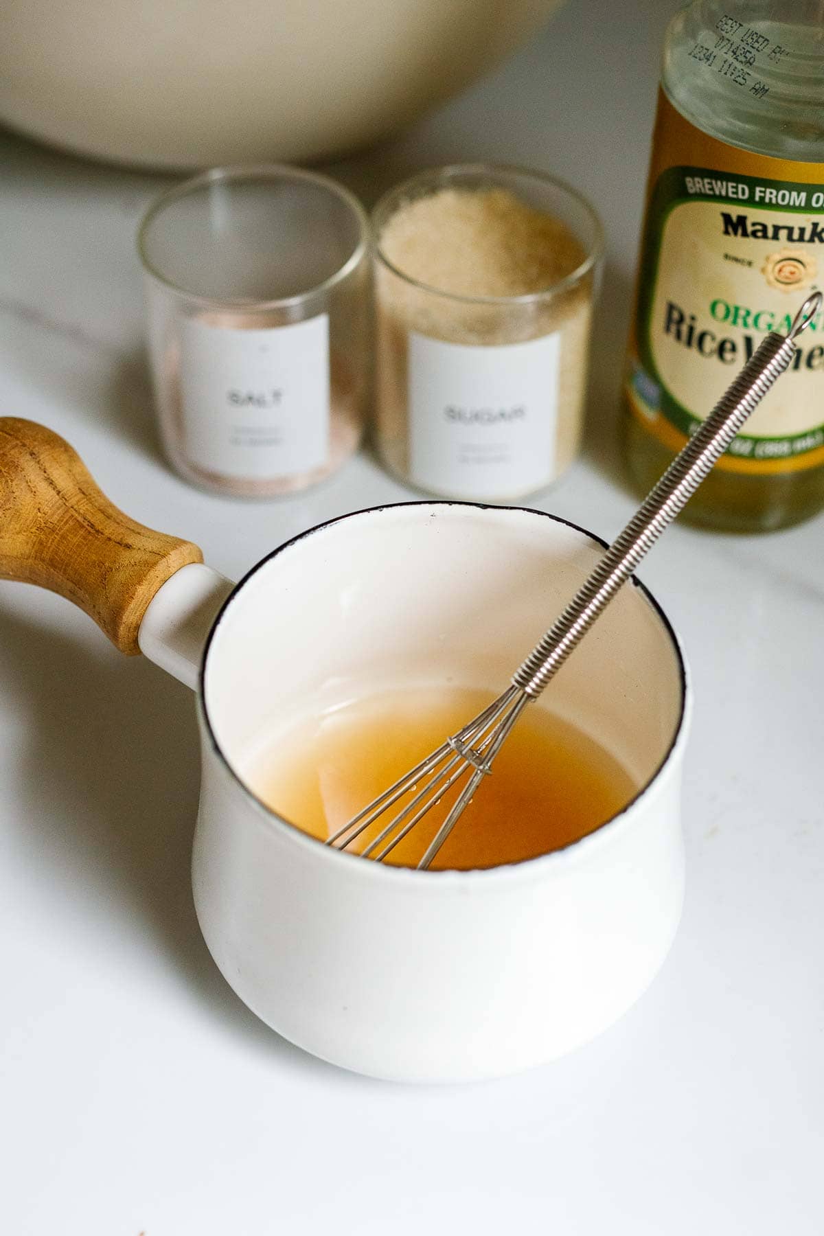 small pot with rice vinegar mixture and whisk.