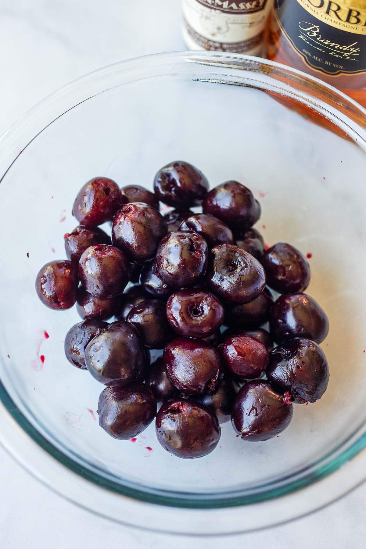 cherries in glass bowl soaked in brandy and vanilla.