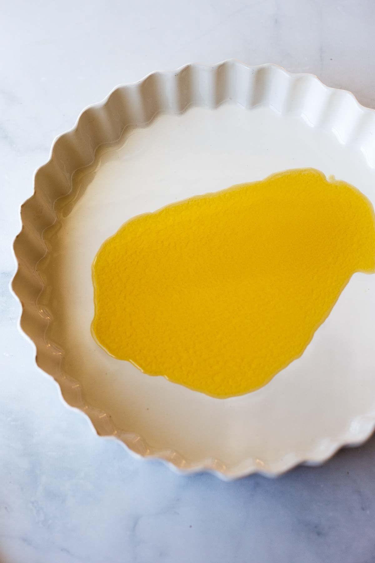 melted butter spread out in round baking dish.