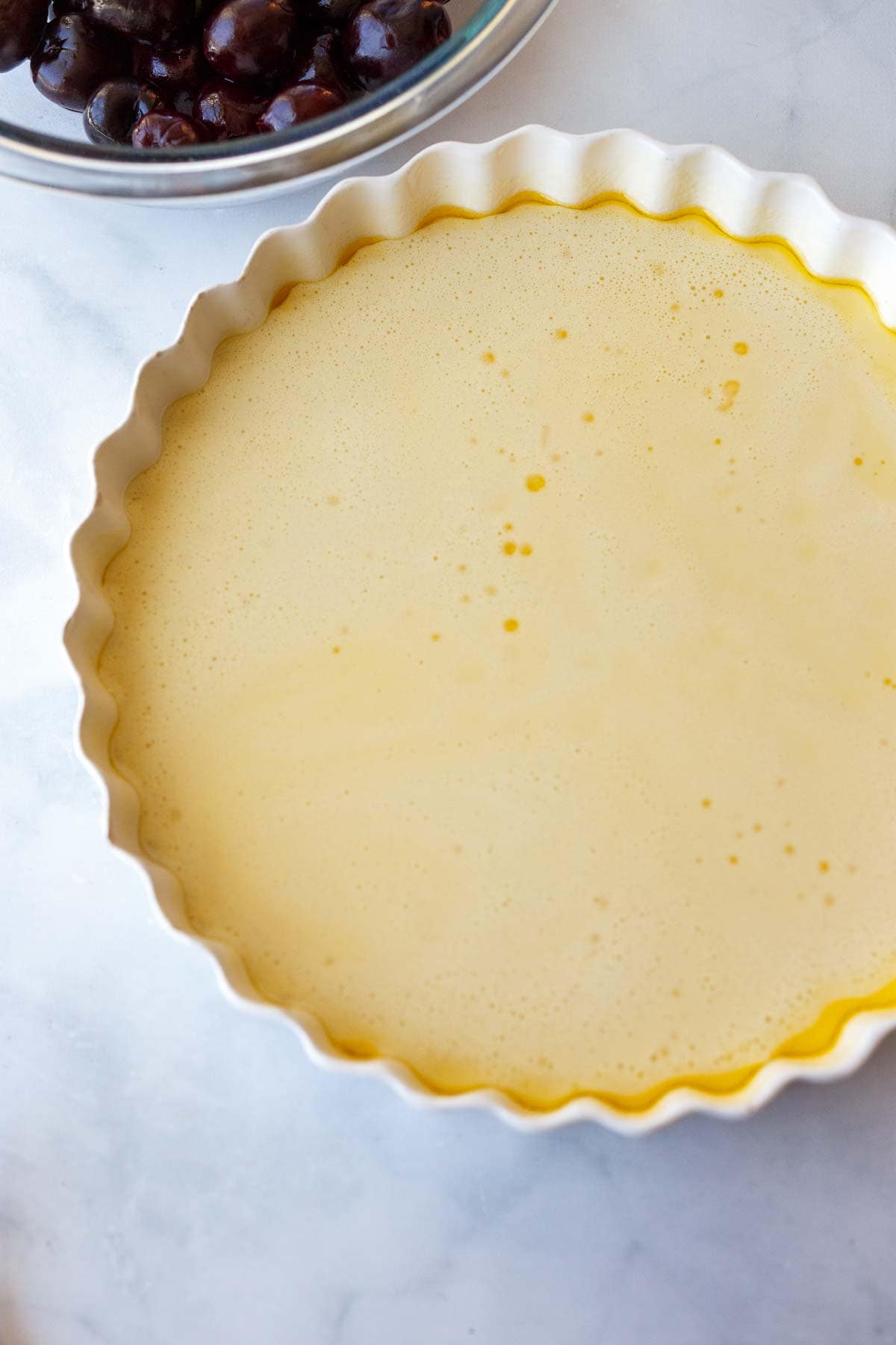 custard filling unbaked in round baking dish.