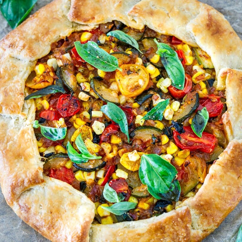 This savory galette is filled with summer tomatoes, corn, and zucchini, with ricotta, basil and parmesan baked in a free-form pie crust until beautifully golden. Allow 1 hour refrigeration time.