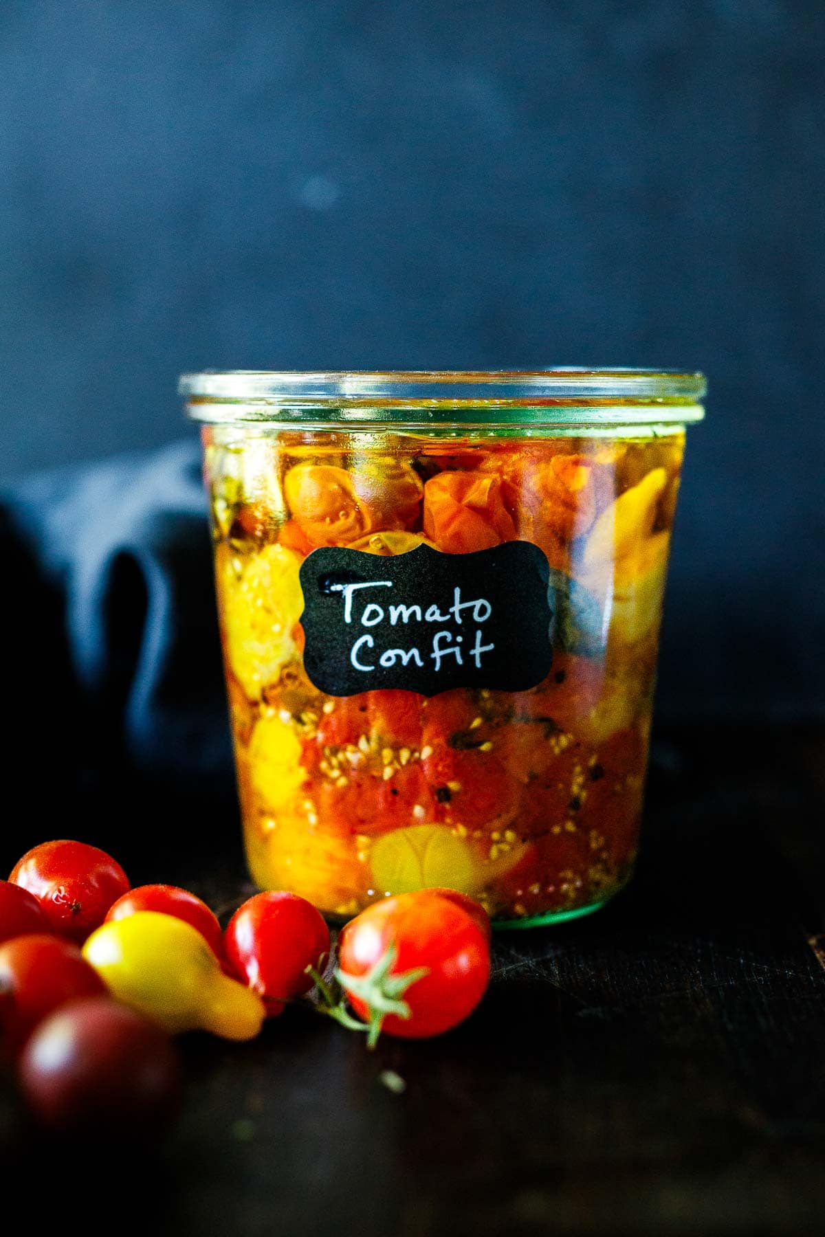 50+ fresh tomato recipes for summer! Cherry tomato confit in a jar with a label. 