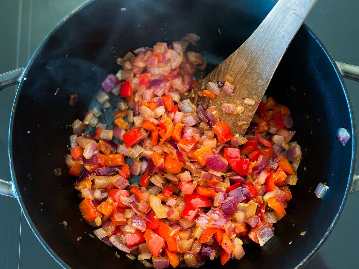 pot with sautéed onions, garlic, and bell peppers diced.