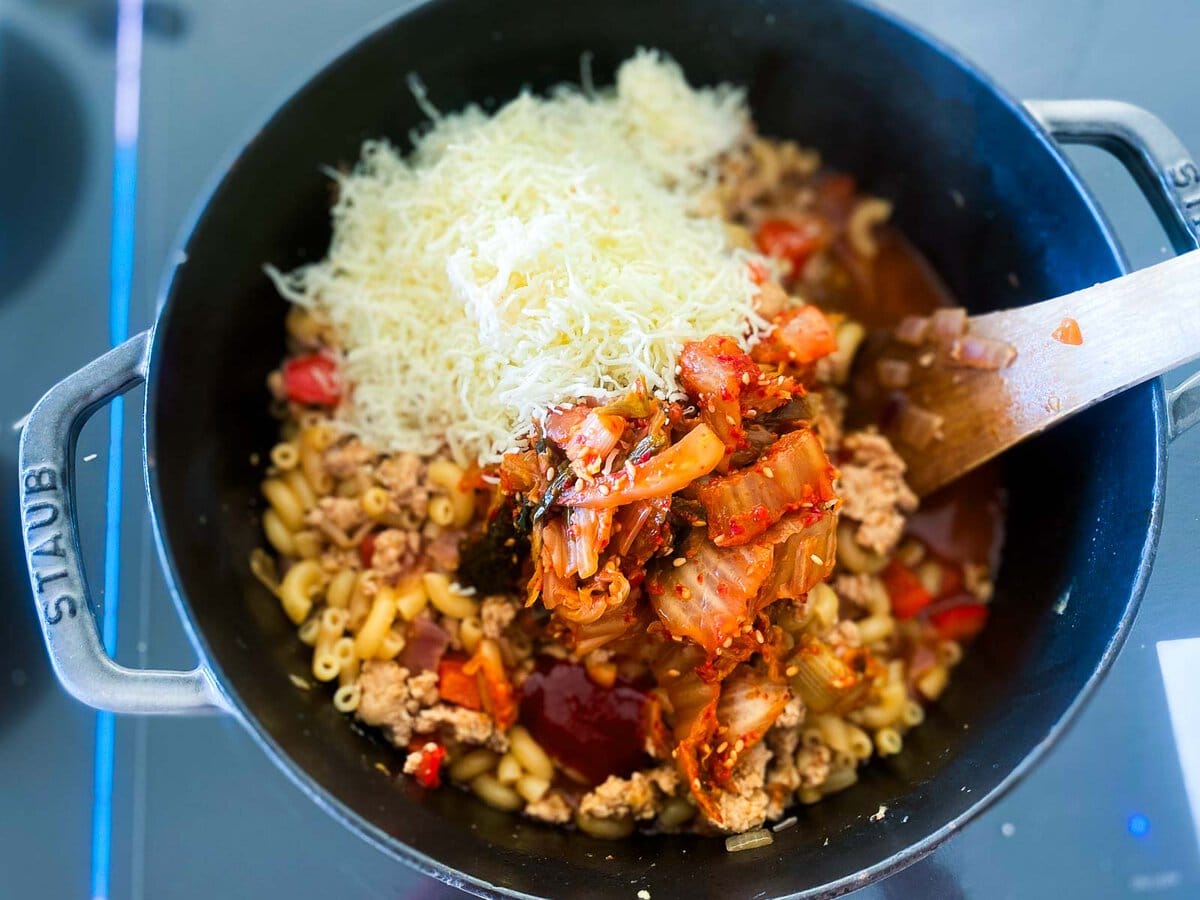 shredded cheddar cheese and kimchi added to large pot with macaroni and ground turkey and veggies.
