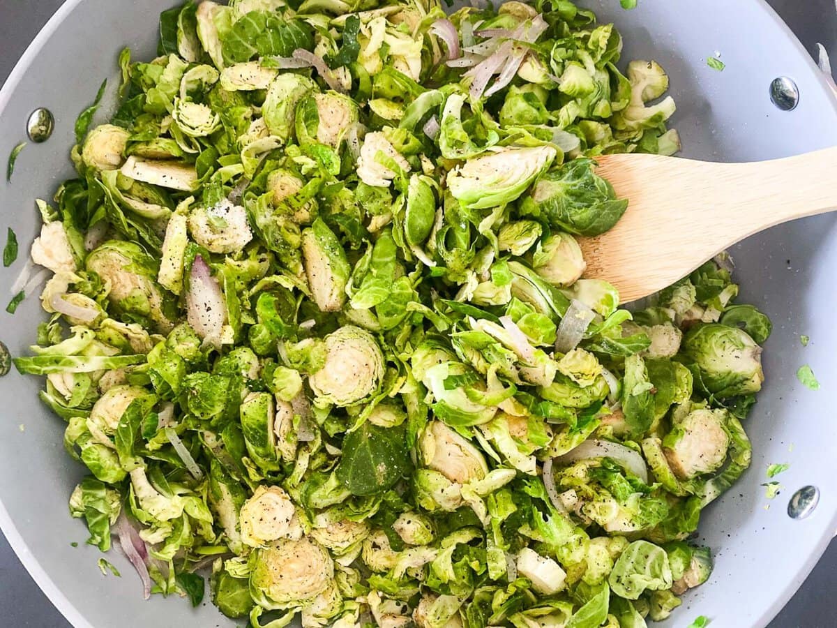 skillet with shredded Brussels sprouts and sauteed shallots and garlic. 