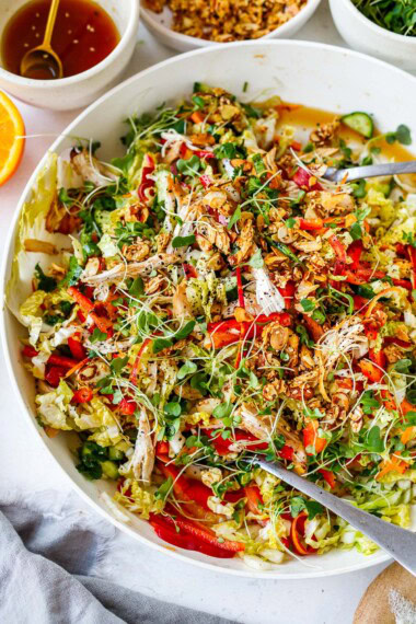 This Chinese Chicken Salad recipe is made with crisp napa cabbage, sesame chicken, crunchy veggies, fresh herbs, and the best dressing ever, topped with sesame almond brittle. Vegan-adaptable.
