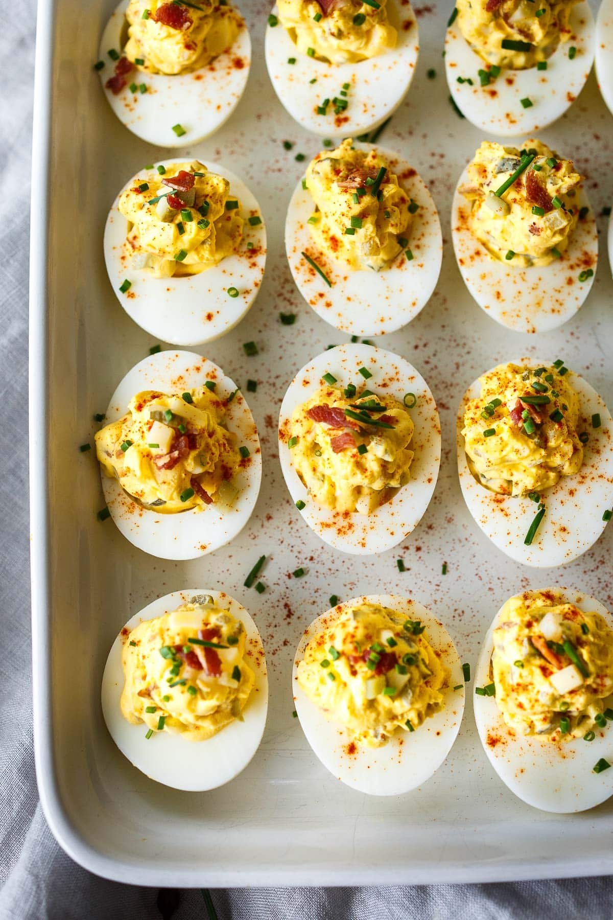 Deviled eggs are a classic appetizer, perfect for potlucks, gatherings, and holidays like Easter. Ours include bacon, cheddar, onion & pickles.